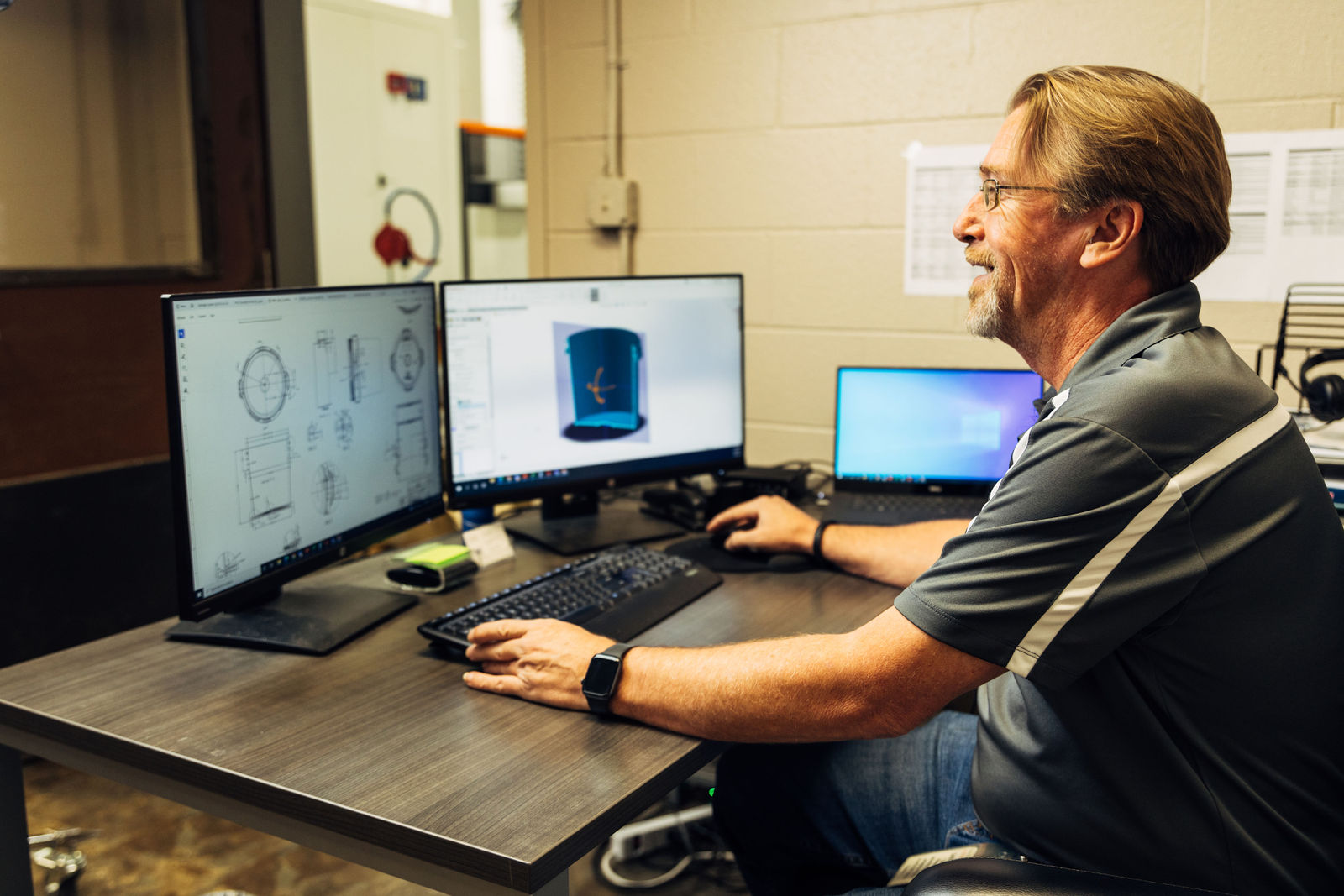 man in the front of the computer smiling